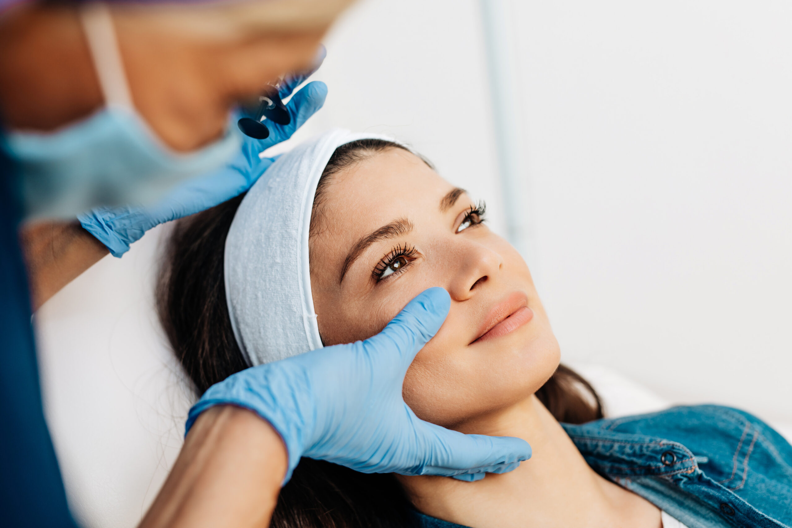 Woman having her face examined by a specialist