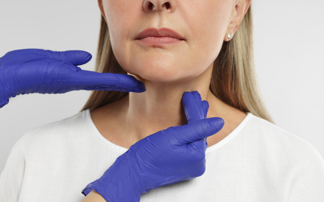 A Specialist examining the chin fat of a cosmetic patient.
