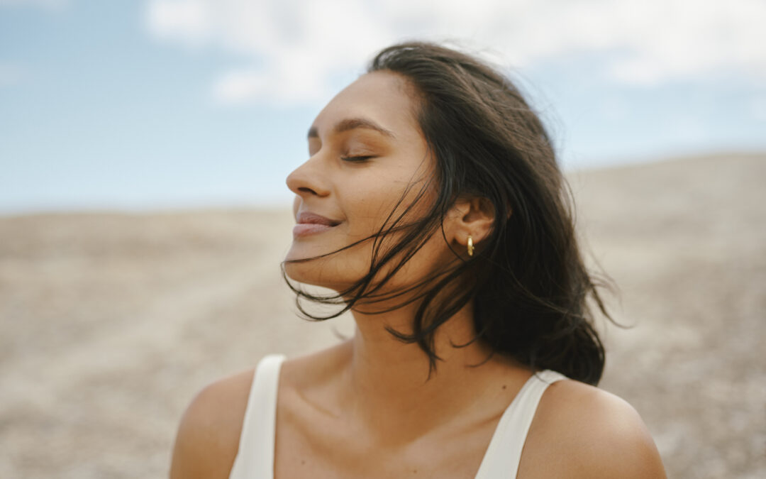 Woman With Glowing Skin Enjoying a Peaceful Breeze