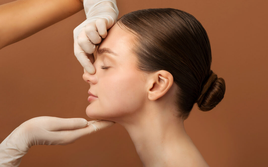 Surgeon touching woman's nose before rhinoplasty operation